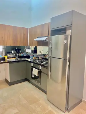 a kitchen with a stainless steel refrigerator at Take the Best Rest Near the airport in Nouaceur