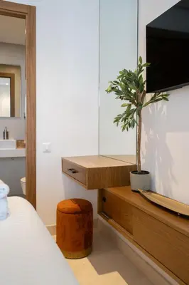 a bedroom with a tv and a potted plant at Résidence Citadelle - Gauthier in Casablanca