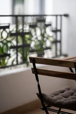 a wooden bench sitting in front of a window at Résidence Citadelle - Gauthier in Casablanca