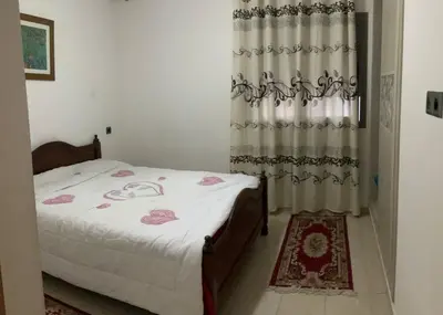 a bedroom with a bed and a curtain at Nice Apartment in Blanca Beach in Sidi Rahal