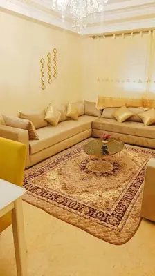 a living room with a couch and a table at appartamento in residenza protetta con piscina in Mohammedia