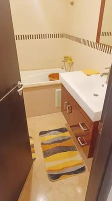 a bathroom with a sink and a towel on the floor at appartamento in residenza protetta con piscina in Mohammedia