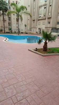 a courtyard with a swimming pool in a building at appartamento in residenza protetta con piscina in Mohammedia