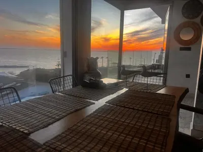 a room with two beds and a view of the ocean at Appartement vue sur mer résidence Les vagues des sablettes Mansouria in Mohammedia