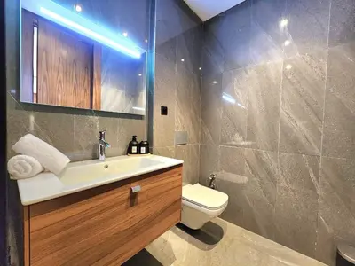 a bathroom with a sink and a toilet and a mirror at Casa finance city - Anfa Park - CFC in Casablanca