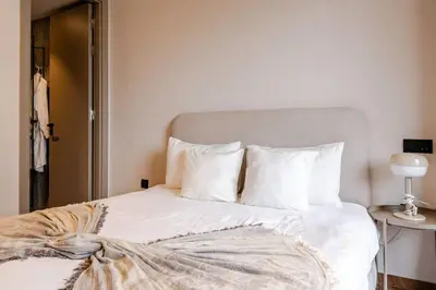 a bedroom with a bed with white sheets and pillows at Cozy Luxurious Bourgogne Studio in Casablanca