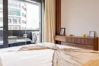 a bedroom with a bed and a large window at Cozy Luxurious Bourgogne Studio in Casablanca