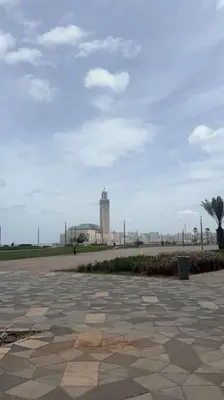 a stone walkway with a clock tower in the distance at Casa Bay in Casablanca