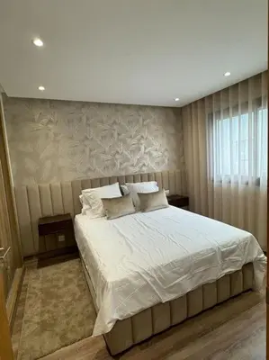 a bedroom with a large bed with white sheets at Casa Bay in Casablanca