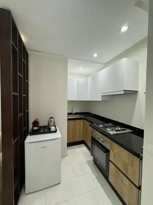 a kitchen with white cabinets and a stove top oven at Casa Bay in Casablanca