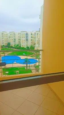 a view of a pool from a window in a building at Bouznika in Bouznika