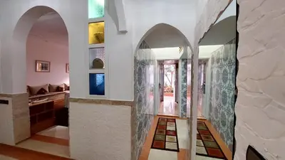 a room with a hallway with arched ceilings and a room with at Taddart, Maison de vacances in Temara