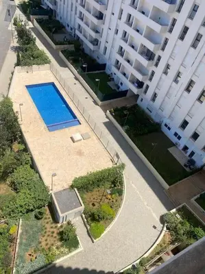 an overhead view of a swimming pool next to a building at Moderne et luxueux in Rabat