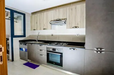 a kitchen with stainless steel appliances and a stove at Moderne et luxueux in Rabat