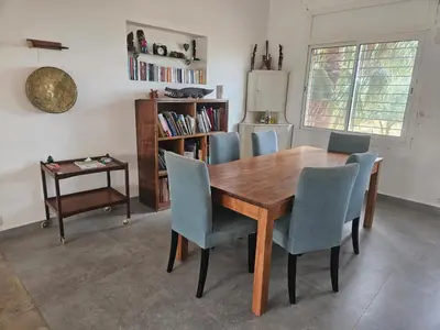 a dining room with a wooden table and chairs at Premium farmhouse with pool in Rabat