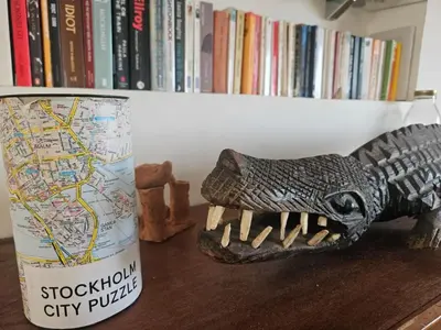 a toy dinosaur on a table next to a cup at Premium farmhouse with pool in Rabat