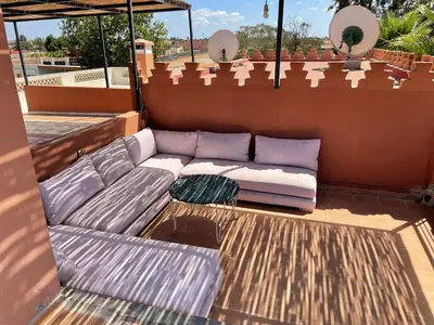 a couch sitting on top of a roof at Premium farmhouse with pool in Rabat