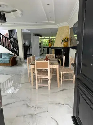a dining room with a table and chairs at Villa en bord de plage, située dans une résidence à El Mansouria, idéale pour une grande famille ou pour des personnes seules in Mansouria