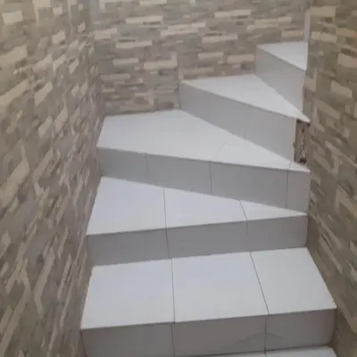 a set of white stairs against a brick wall at Captivating 4-Bed House in Tamaris in Tamaris
