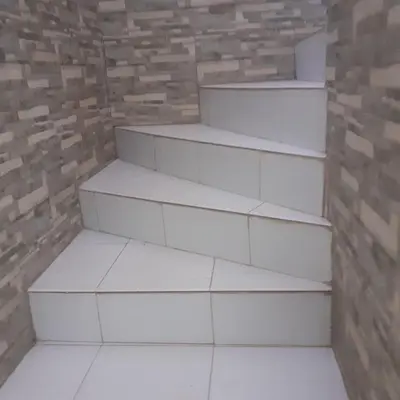 a set of white stairs in a brick wall at Captivating 4-Bed House in Tamaris in Tamaris