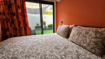 a bedroom with a bed and a large window at Sunny apartment with terrace near CasaFiananceCity in Casablanca