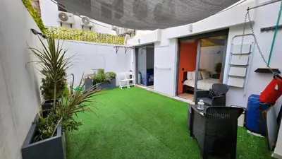 an apartment patio with green grass and plants at Sunny apartment with terrace near CasaFiananceCity in Casablanca