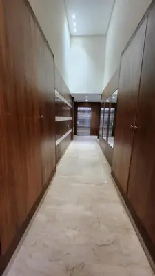 an empty corridor with wooden cabinets and a hallway with a corridorngthngthngthngth at Sunny apartment with terrace near CasaFiananceCity in Casablanca