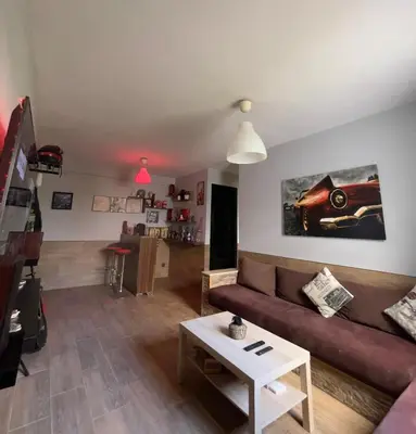 a living room with a couch and a table at Cozy Apartment Dar Bouazza in Casablanca