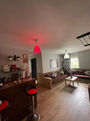 a living room with red lights on the ceiling at Cozy Apartment Dar Bouazza in Casablanca