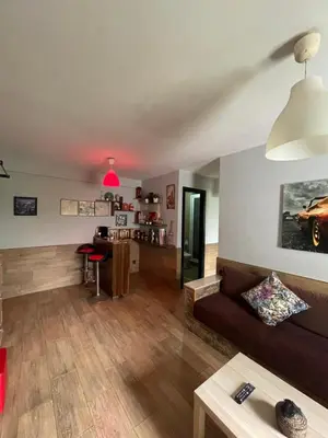 a living room with a couch and a table at Cozy Apartment Dar Bouazza in Casablanca