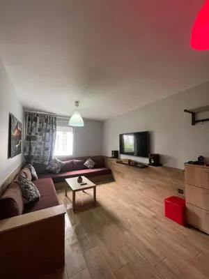 a living room with a couch and a flat screen tv at Cozy Apartment Dar Bouazza in Casablanca