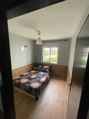 a bedroom with a bed and a window at Cozy Apartment Dar Bouazza in Casablanca