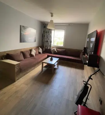 a living room with a couch and a coffee table at Cozy Apartment Dar Bouazza in Casablanca