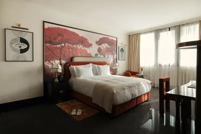 a bedroom with a bed and a large painting on the wall at Marly Boutique Hôtel in Casablanca