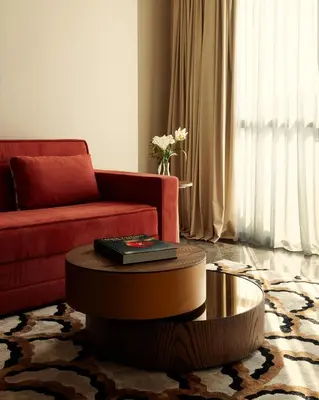 a living room with a red couch and a coffee table at Marly Boutique Hôtel in Casablanca