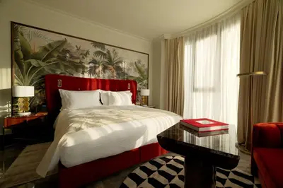 a bedroom with a bed with a large painting on the wall at Marly Boutique Hôtel in Casablanca