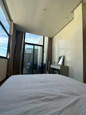 a bedroom with a large bed and a large window at Luxurious apartment in the heart of Maarif Casa in Casablanca