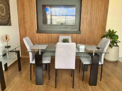 a dining room with a glass table and chairs at Luxurious apartment in the heart of Maarif Casa in Casablanca
