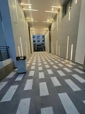 an empty hallway of an office building with lights at Luxurious apartment in the heart of Maarif Casa in Casablanca