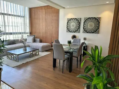 a living room with a table and a couch at Luxurious apartment in the heart of Maarif Casa in Casablanca