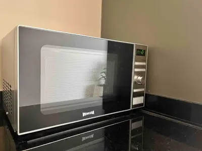 a microwave oven sitting on top of a counter at Luxurious apartment in the heart of Maarif Casa in Casablanca