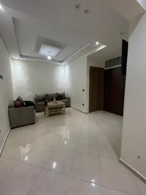 a living room with a couch and a table at Appartement spacieux et calme à proximité de la mer et la gare agdal in Rabat