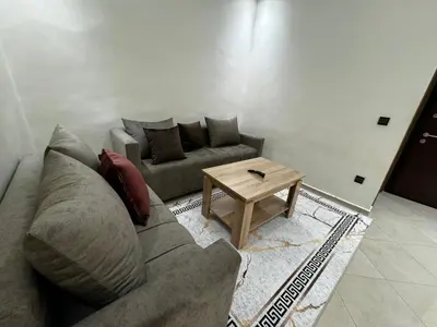 a living room with a couch and a coffee table at Appartement spacieux et calme à proximité de la mer et la gare agdal in Rabat