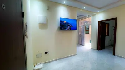 a hallway with a wall with a painting on it at Appartement spacieux et calme à proximité de la mer et la gare agdal in Rabat