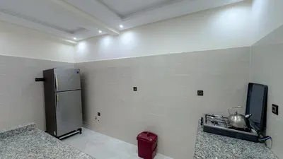 a kitchen with a refrigerator and a sink in it at Appartement spacieux et calme à proximité de la mer et la gare agdal in Rabat
