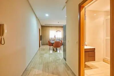 a hallway with a table and a dining room at City Escape Modern 1-Bed Near Casa Voyageurs in Casablanca