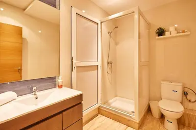 a bathroom with a shower and a toilet and a sink at City Escape Modern 1-Bed Near Casa Voyageurs in Casablanca