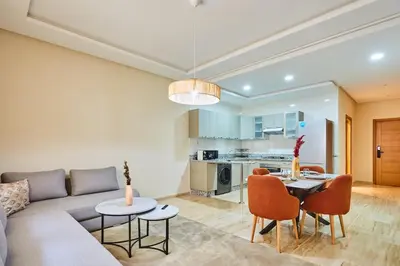 a living room with a couch and a table and chairs at City Escape Modern 1-Bed Near Casa Voyageurs in Casablanca