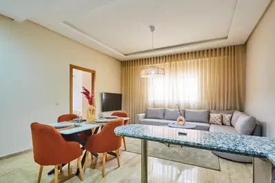 a living room with a couch and a table and chairs at City Escape Modern 1-Bed Near Casa Voyageurs in Casablanca