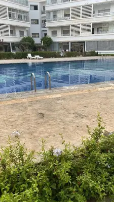 a large swimming pool in front of a large building at Résidence Balnéaire, Appartement 2 Chambres in Mansouria